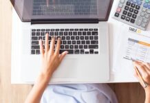 How HR Software Pricing Transparency Helps SMEs Plan Their Digitalisation Budget overhead-view-of-person-calculating-budget-near-a-keyboard