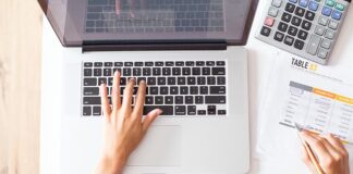 How HR Software Pricing Transparency Helps SMEs Plan Their Digitalisation Budget overhead-view-of-person-calculating-budget-near-a-keyboard