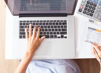 How HR Software Pricing Transparency Helps SMEs Plan Their Digitalisation Budget overhead-view-of-person-calculating-budget-near-a-keyboard