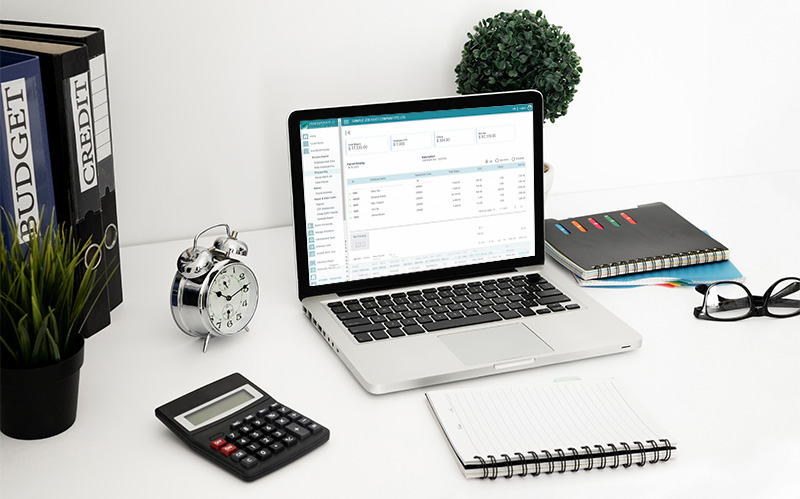 open-hr-payroll-software-dashboard-on-laptop-with-desk-calculator