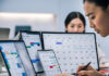 How Shift Roster Planning Helps SMEs Control Labour Costs SME-employee-managing-employee-work-schedules-on-multiple-screens