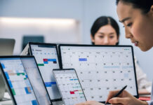 How Shift Roster Planning Helps SMEs Control Labour Costs SME-employee-managing-employee-work-schedules-on-multiple-screens