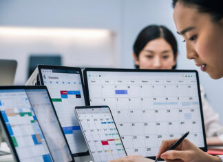 How Shift Roster Planning Helps SMEs Control Labour Costs SME-employee-managing-employee-work-schedules-on-multiple-screens