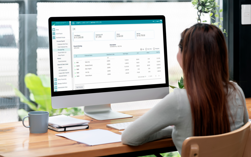 Woman managing payroll system to track construction labour costs