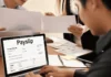 AI in Payroll Processing: How It Helps HR Teams Work Faster and More Accurately employee viewing digital payslip on laptop during payroll processing