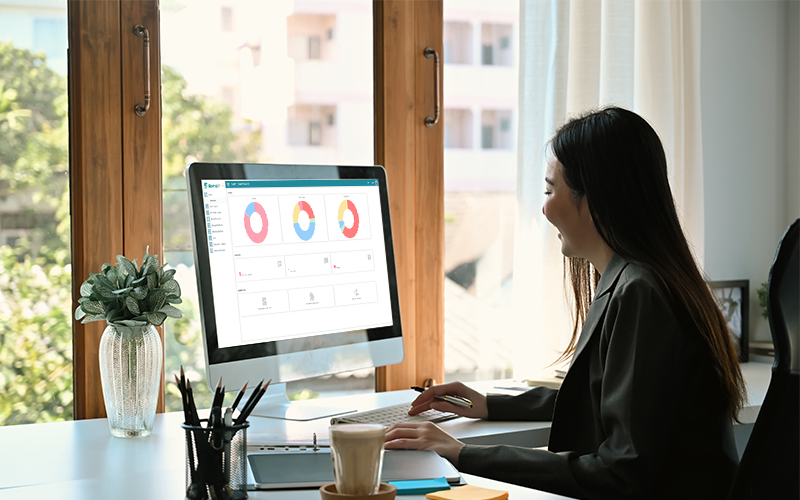 AWoman analyzing workforce data on a secure HR software dashboard.