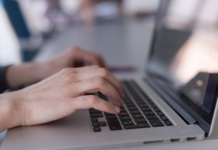 Why HR Data Accuracy Matters Before SMEs Automate Payroll and Workforce Reports Hands typing accurate payroll data on a laptop keyboard.