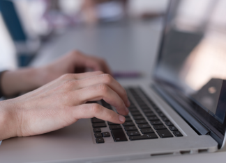 Why HR Data Accuracy Matters Before SMEs Automate Payroll and Workforce Reports Hands typing accurate payroll data on a laptop keyboard.