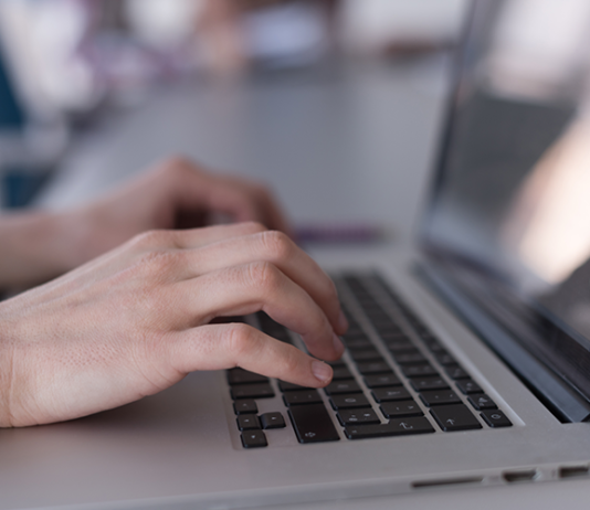 Why HR Data Accuracy Matters Before SMEs Automate Payroll and Workforce Reports Hands typing accurate payroll data on a laptop keyboard.