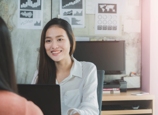 AI in HR Software: 7 Ways SMEs Can Reduce Manual HR Work smiling-businesswoman-job-interview-laptop-office
