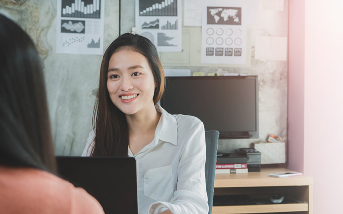smiling-businesswoman-job-interview-laptop-office