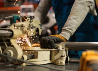 Manufacturing Job Costing Software: Labour Cost by Job, Batch, or Project factory-worker-cutting-metal-pipe-in-manufacturing-labour-production